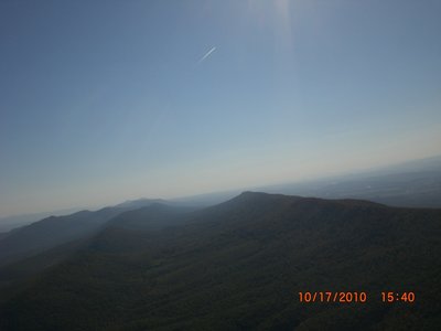 Sunrays, a jetliner, and the valley behind Short Mountain.